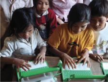 Cambodian schoolchildren using the XO laptop